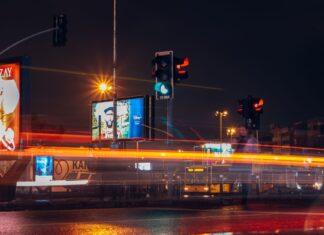 Miasto bez reklam: czego uczą nas przykłady ograniczania chaosu wizualnego w przestrzeni Nocna ulica w mieście z ruchem aut i smugami świateł